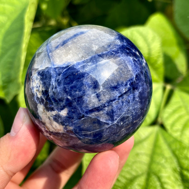 Sodalite gemstone sphere with smooth finish and natural veining