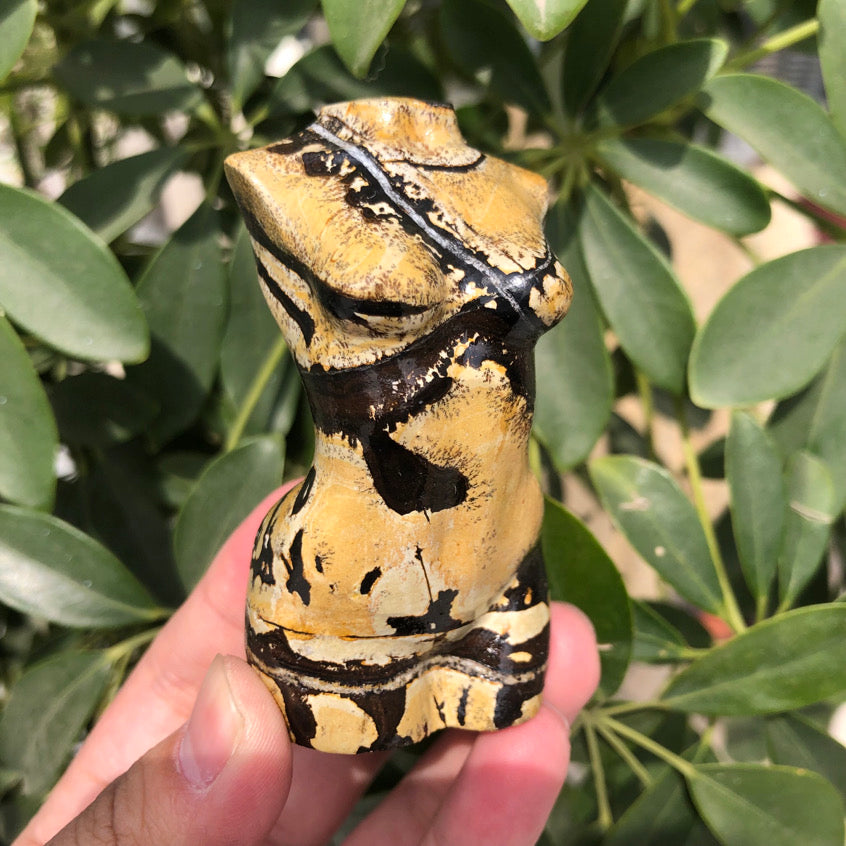 Front view of a Picture Jasper female torso carving with bold dark mineral veins.