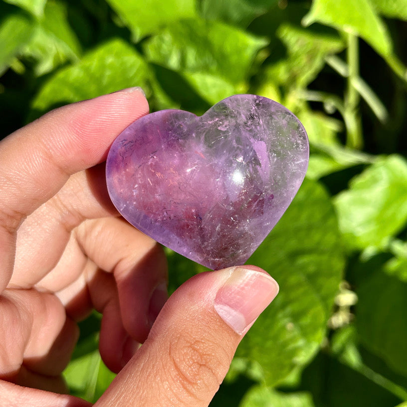 Heart-shaped amethyst carving with natural inclusions and clarity