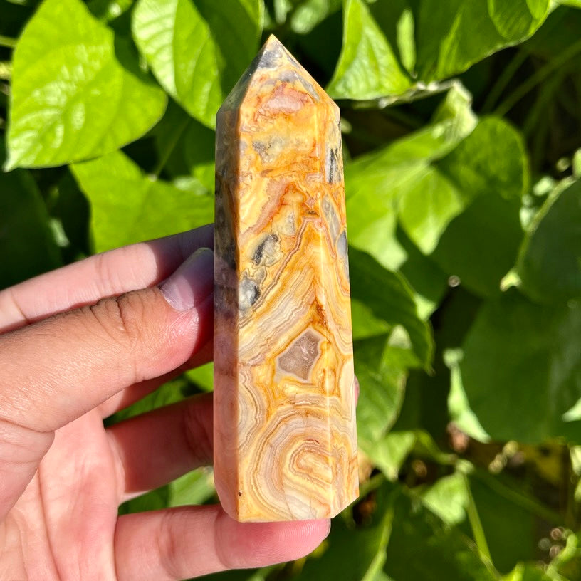 Crazy lace agate crystal tower with swirling yellow and orange patterns