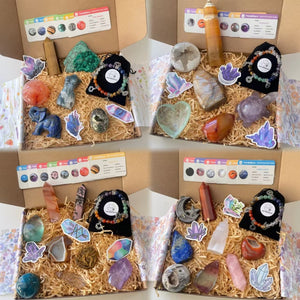 Mystery Crystal Box with assorted carvings, spheres, towers, bracelets, and chakra ID cards in kraft gift packaging.