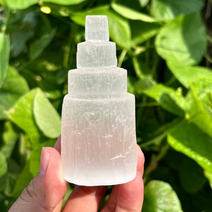 White selenite sculpture shaped as a stepped energy tower