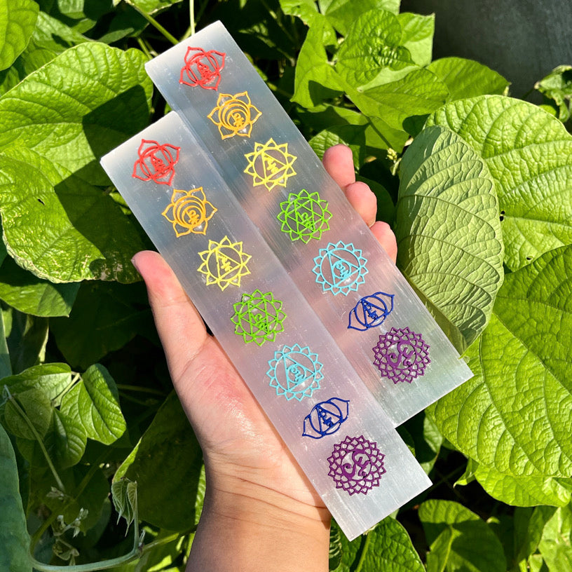 Selenite wand engraved with colorful seven chakra symbols