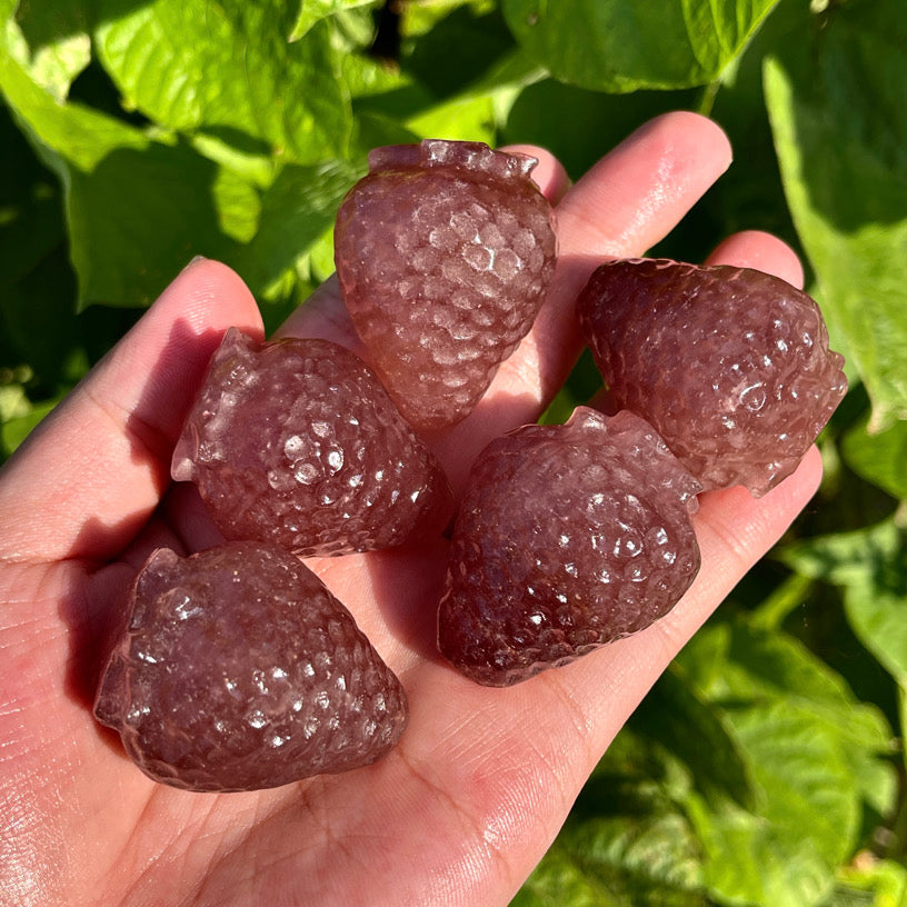 Carved strawberry crystal with natural stone texture and glossy finish