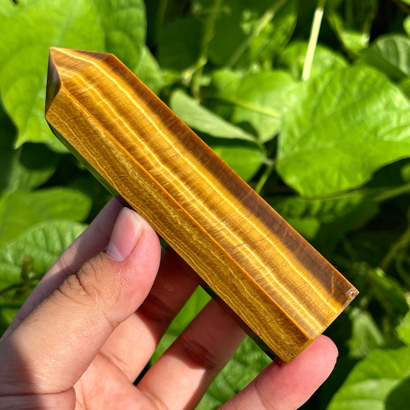 Tiger's eye crystal tower with golden chatoyancy and smooth polish