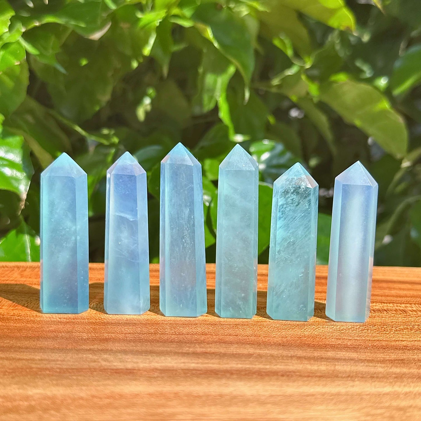 Close-up of a polished Aquamarine tower with its clear blue hues and smooth edges.