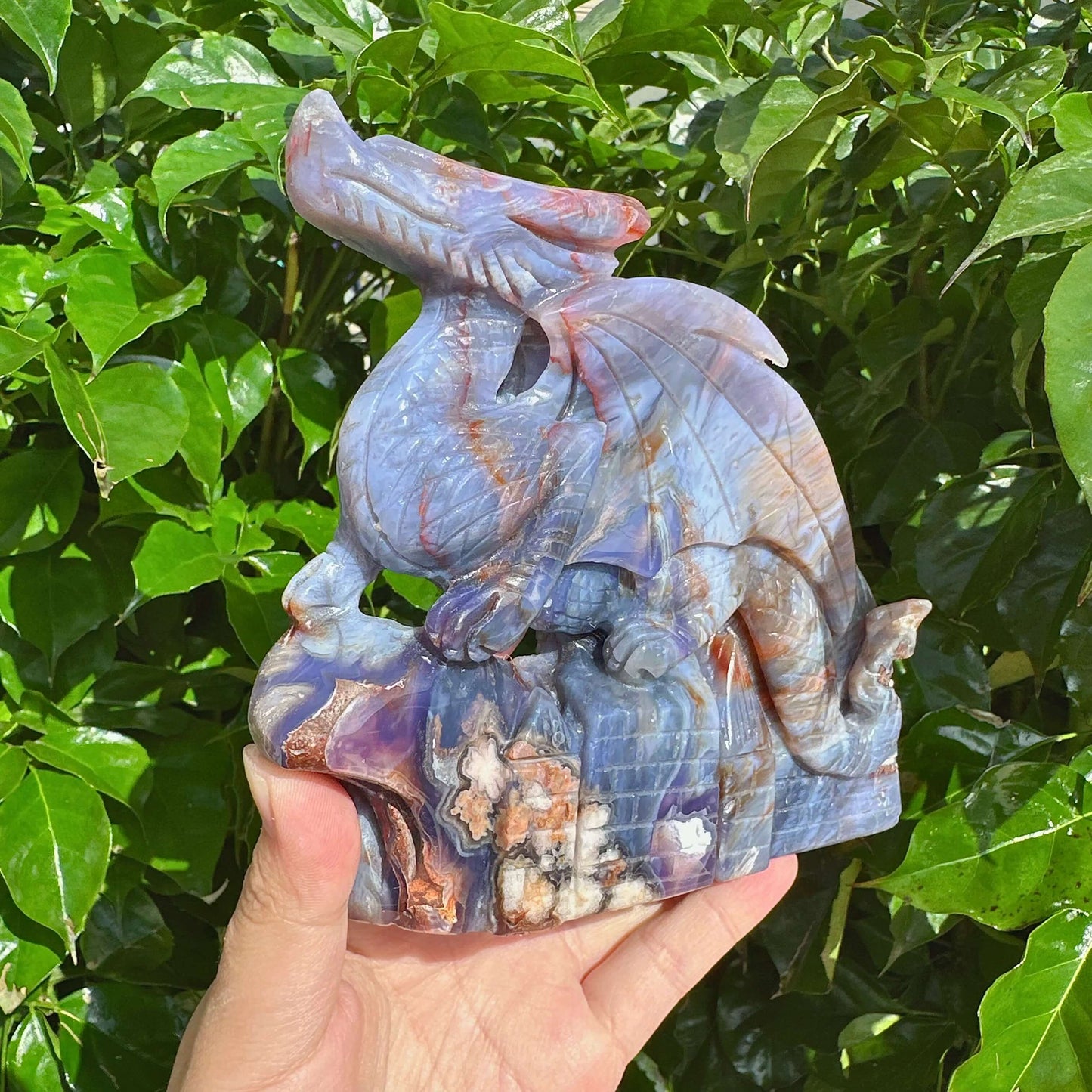 Blue Flower Agate Dragon Carving placed on a display surface with beautiful color contrasts.