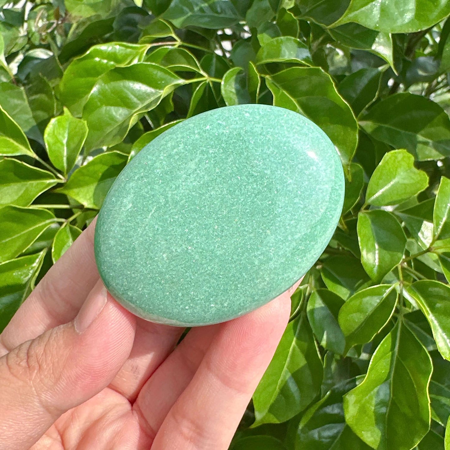 Collection of Green Aventurine Palm Stones, showcasing their smooth surface and energizing qualities.