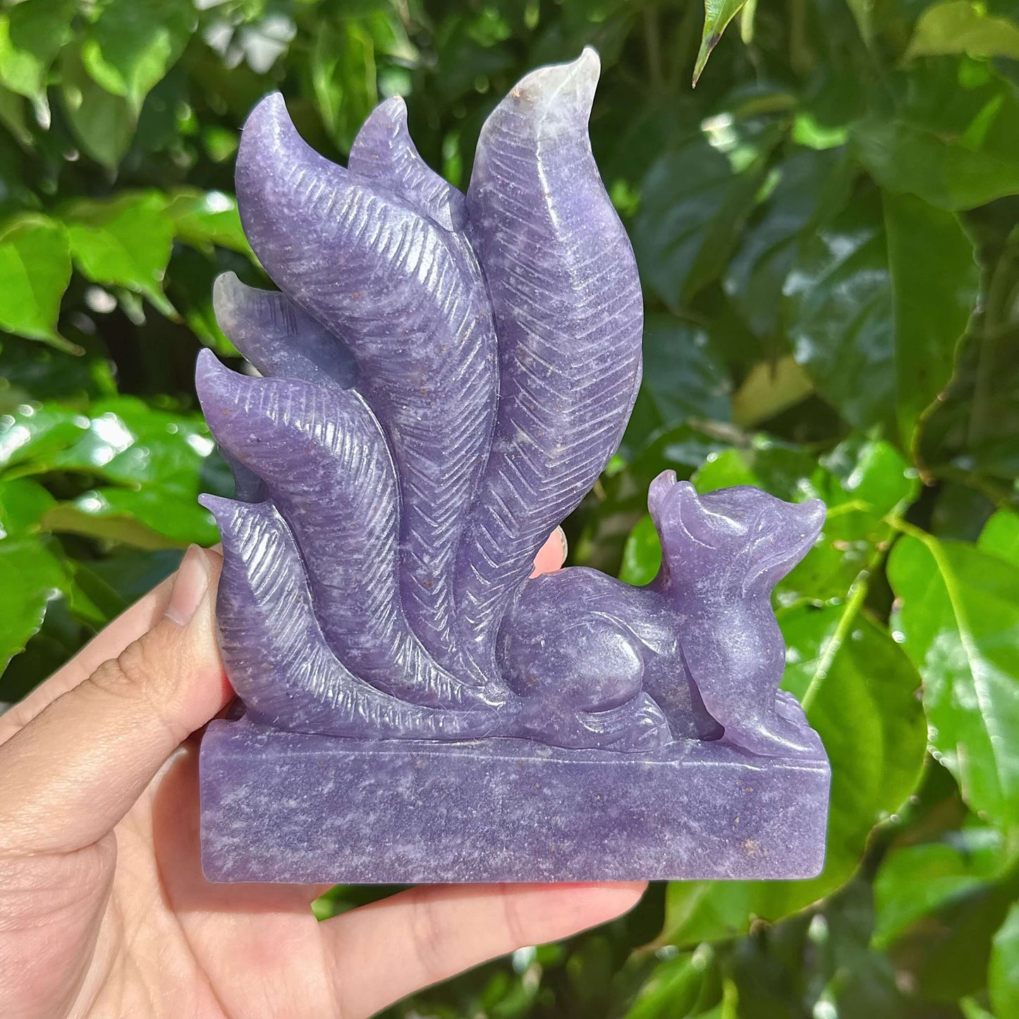 Side view of the Lepidolite Nine-Tailed Fox Carving, highlighting the natural beauty of the crystal.