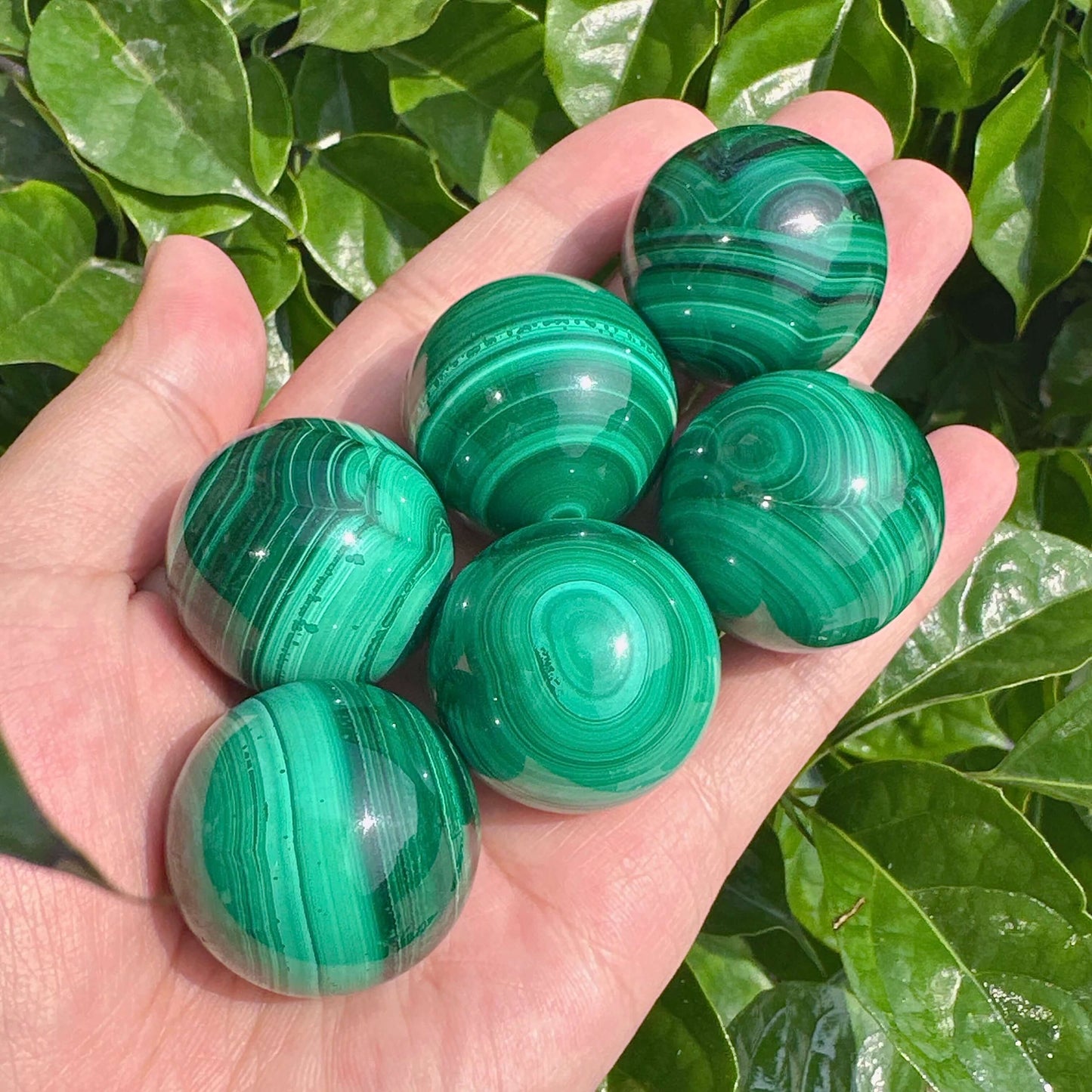 Malachite sphere with vibrant green banding and polished finish