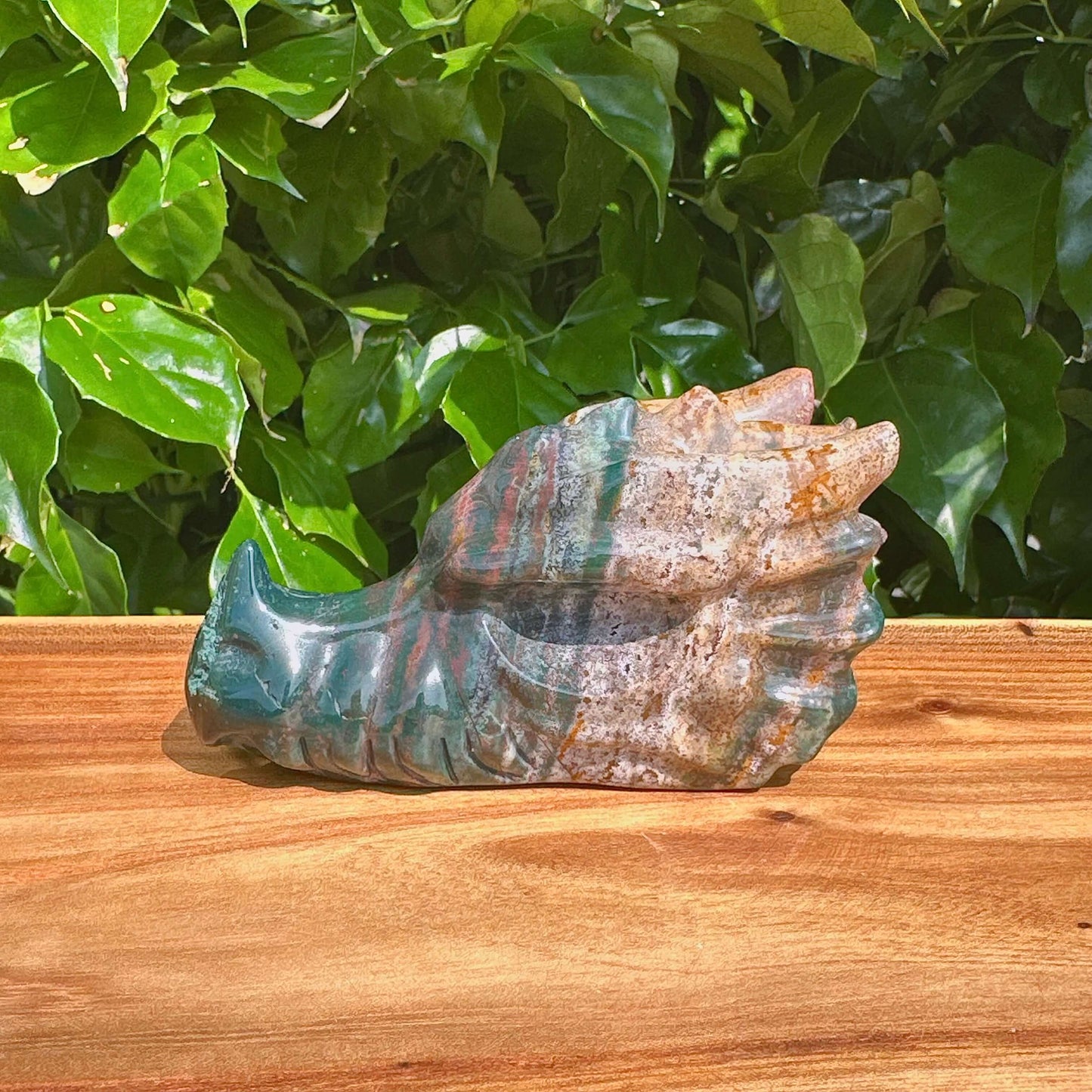 Detailed view of Ocean Jasper Dragon Head Carving featuring its intricate design and colorful patterns.