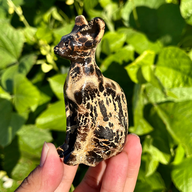Crystal feline figurine in picture jasper, with unique spotted texture and elegant sitting posture.