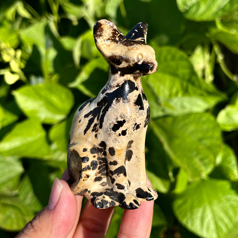 Close-up of a jasper stone cat sculpture with polished finish and hand-sculpted features.