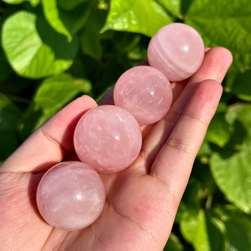 Smooth pink quartz sphere used for love and heart chakra healing