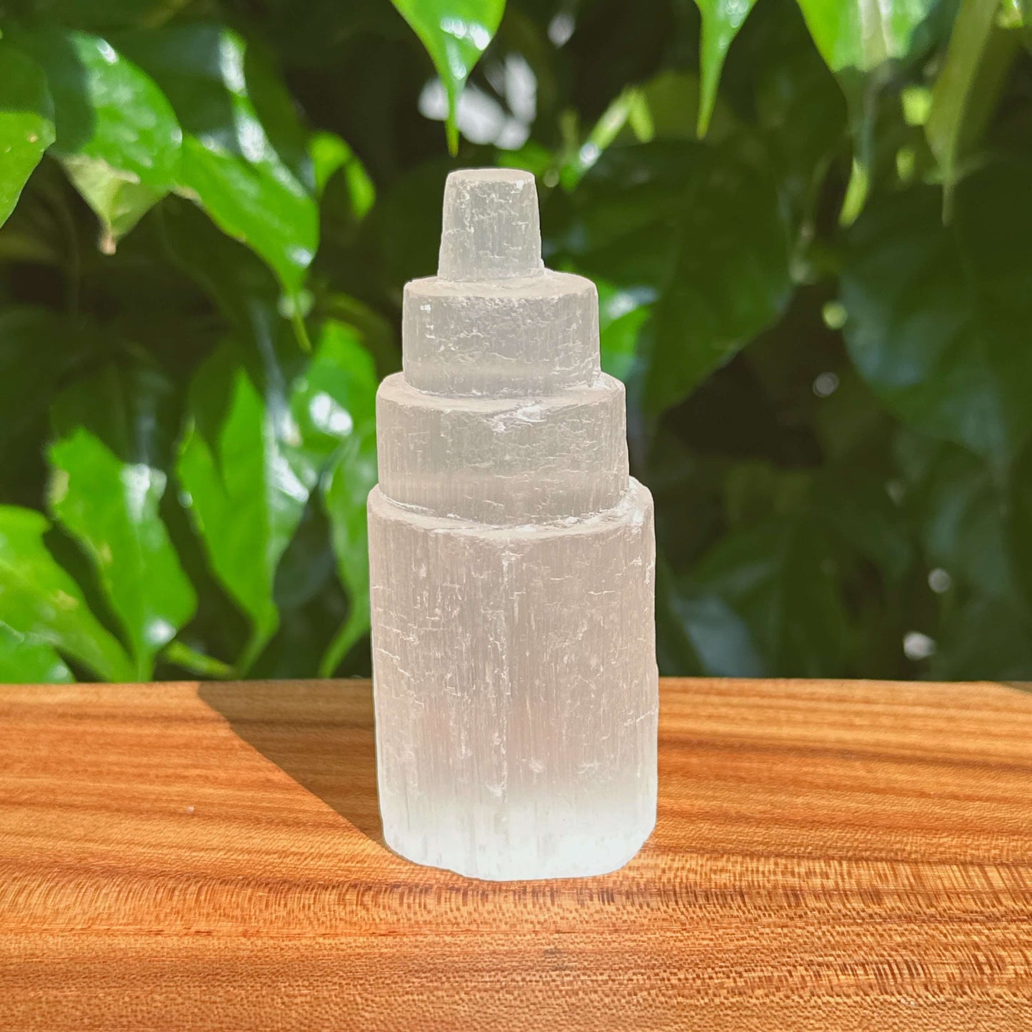 Selenite Tower held in hand, emphasizing its compact size and beautiful crystal structure, ideal for energy healing and meditation.