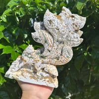 Handheld 8th Vein Ocean Jasper Nine-Tailed Fox Carving, revealing the intricate detail and natural beauty of the stone sculpture.