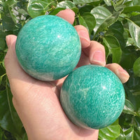 Polished Amazonite sphere with a smooth, glossy finish, highlighting its soothing colors.