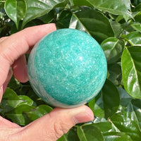 Polished Amazonite sphere with a shiny, smooth surface, offering balance and tranquility.