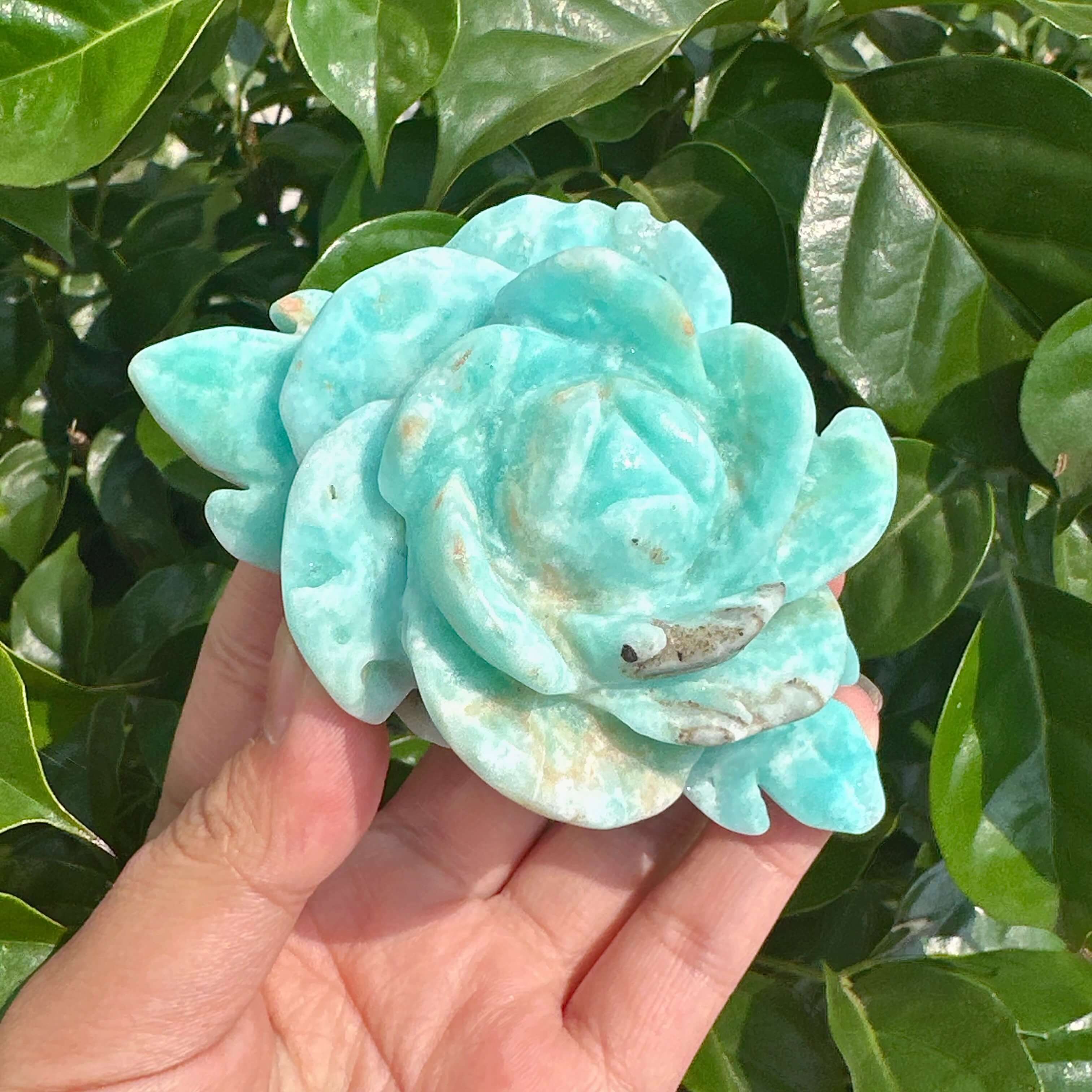 Close-up of three Hemimorphite Rose Carvings, emphasizing the fine details and smooth texture of the natural gemstone.