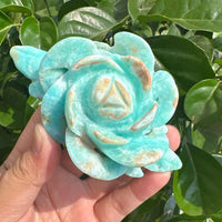 Elegant display of two Hemimorphite Rose Carvings, showcasing the translucent and detailed textures of the stone.