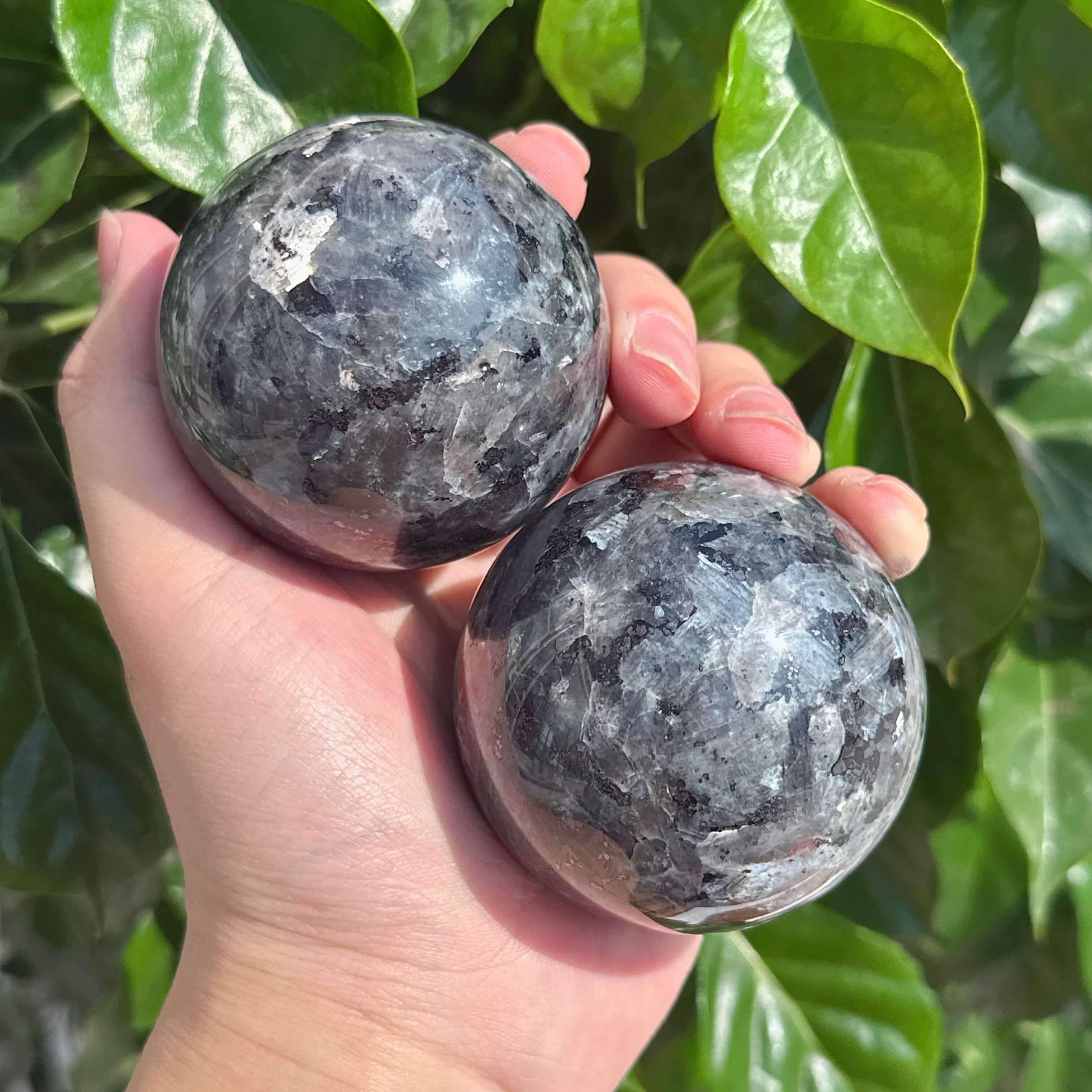 Close-up view of a Larvikite Sphere, showcasing its unique texture and natural mineral patterns, ideal for crystal enthusiasts and energy work.