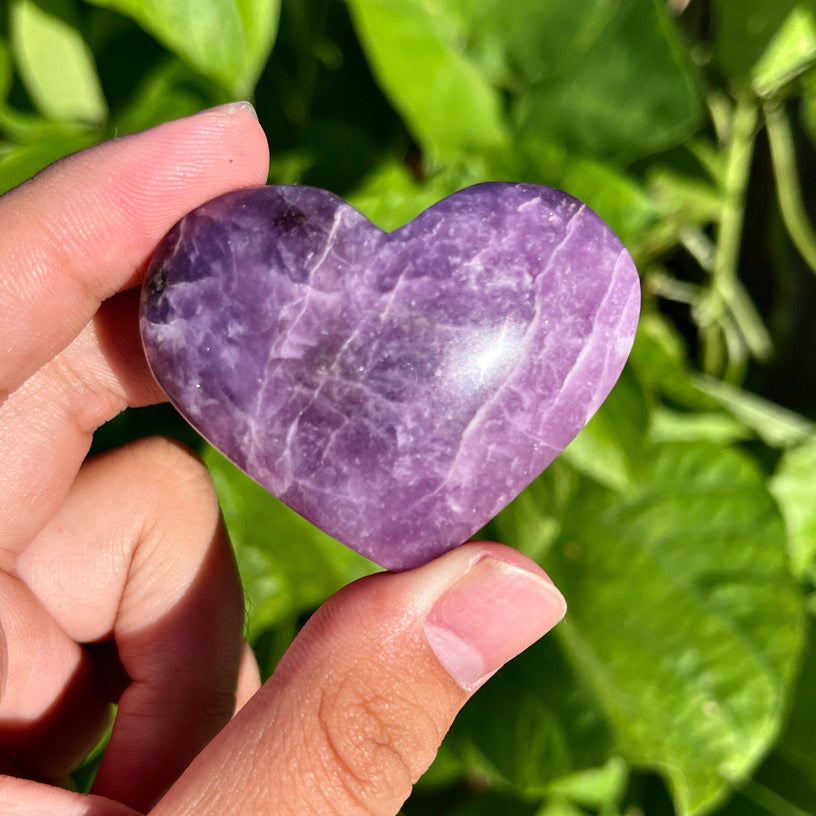 Polished lepidolite gemstone heart featuring natural silver flecks