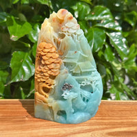 Amazonite landscape carving with intricate mountain and tree details, showcasing the natural beauty of the stone.