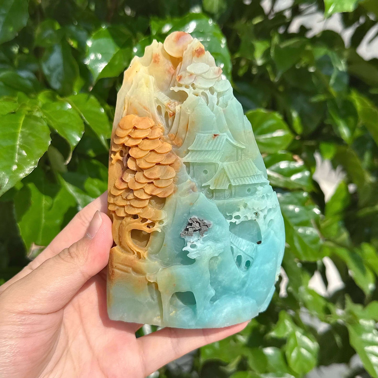 Close-up of an amazonite landscape carving featuring vibrant colors and intricate textures of nature.