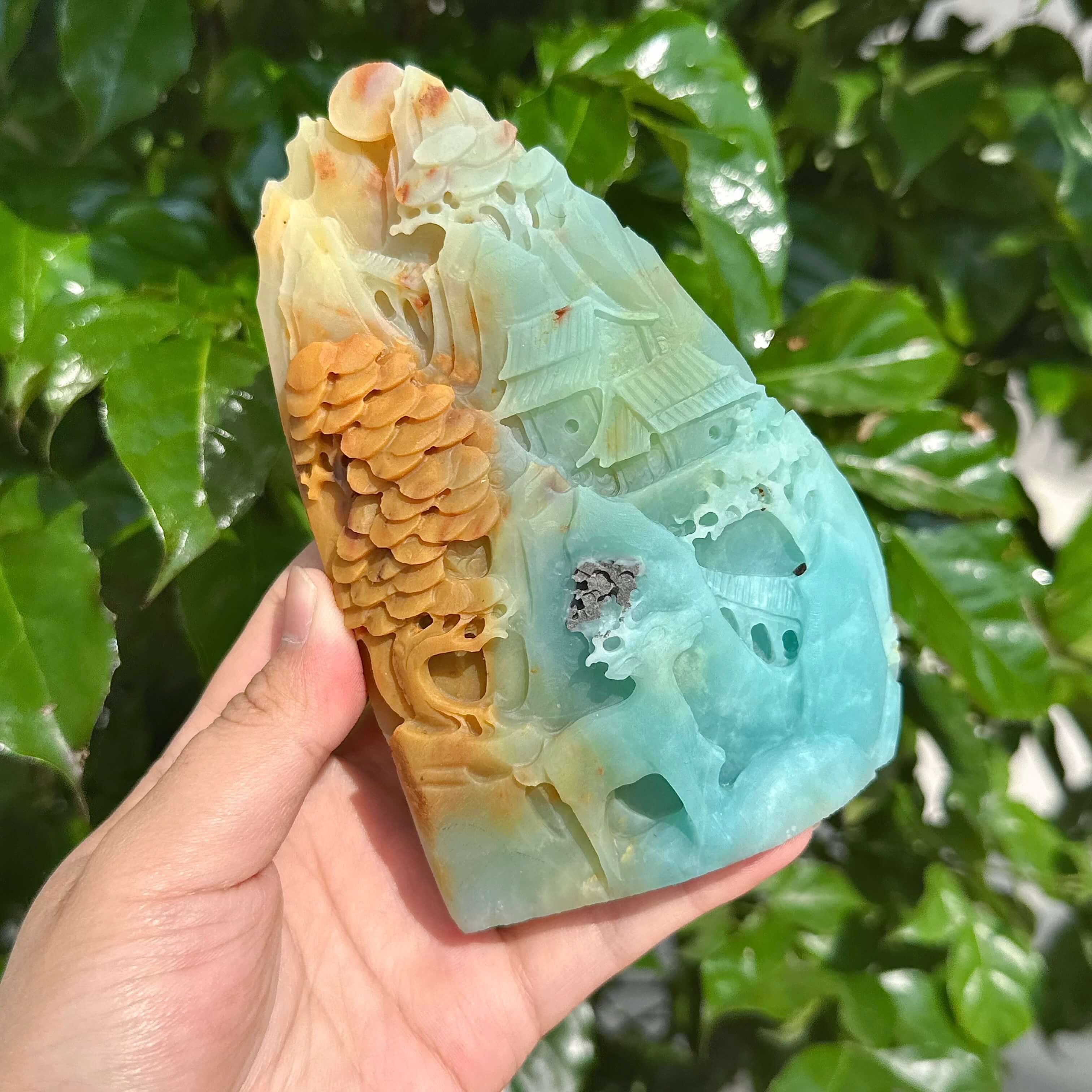 Detailed view of the amazonite landscape carving highlighting trees and flowing textures on the stone.