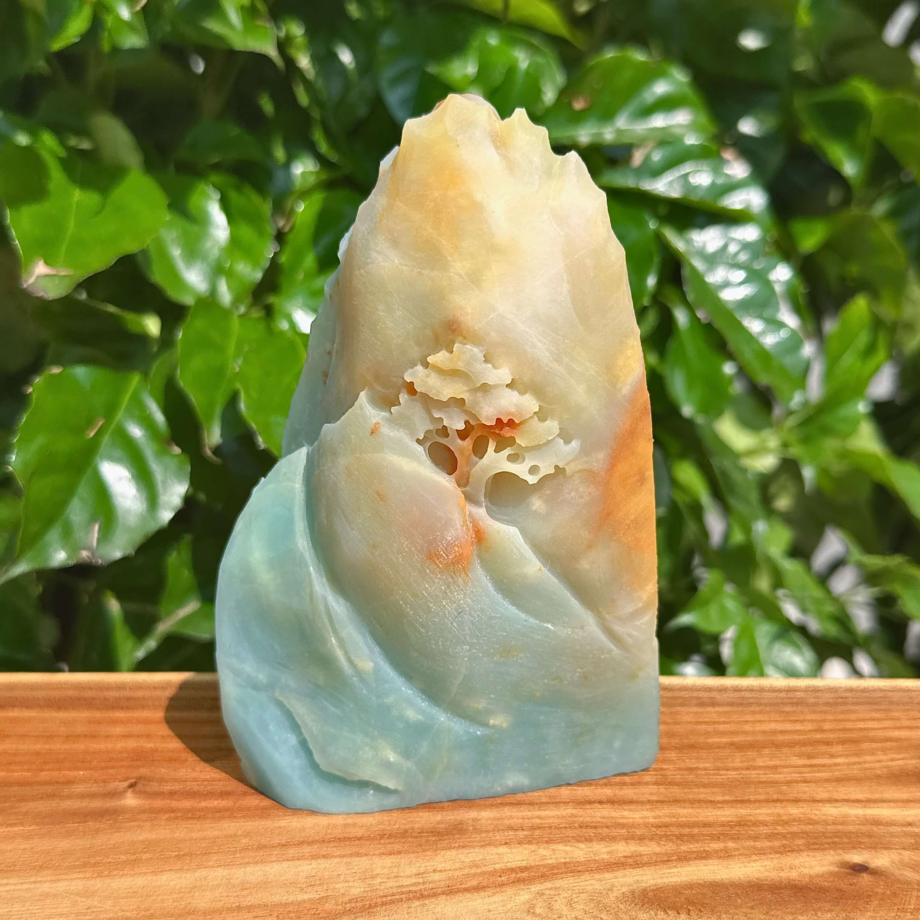 Handcrafted amazonite stone sculpture with natural flowing design, perfect for home decoration.