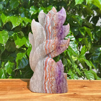 Side view of the Amethyst Agate Nine-Tailed Fox Carving, showcasing the detailed features and color blending of the crystal.