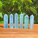 Close-up of a polished Aquamarine tower with its clear blue hues and smooth edges.