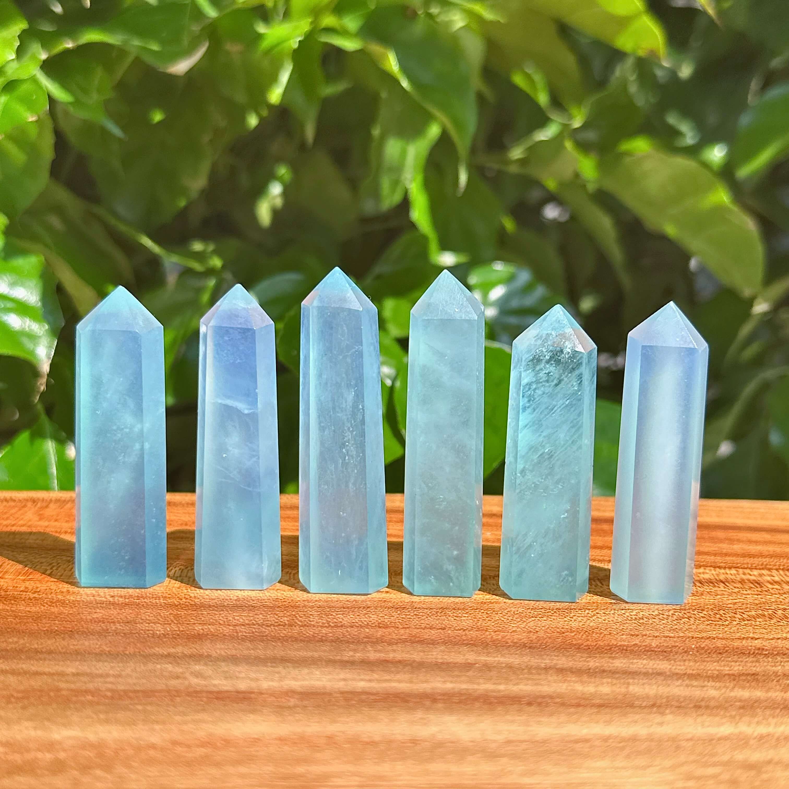 Close-up of a polished Aquamarine tower with its clear blue hues and smooth edges.