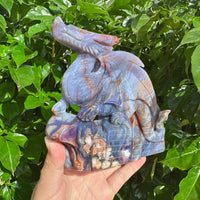 Blue Flower Agate Dragon Carving placed on a display surface with beautiful color contrasts.