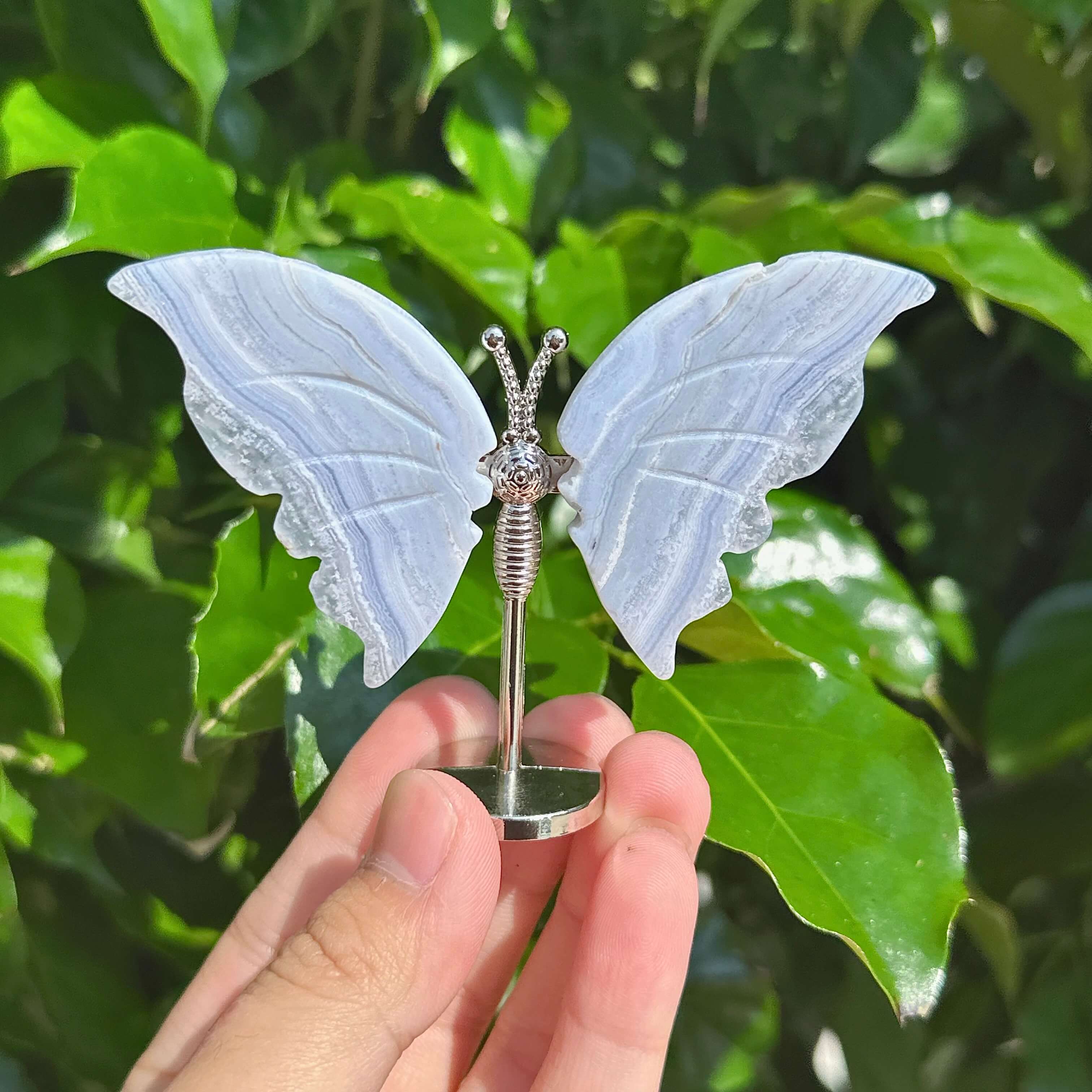 Blue Lace Agate butterfly figurine with intricate wings and silver base, showcasing delicate crystal design.