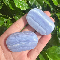 Close-up of Blue Lace Agate Palm, highlighting its soothing blue color and detailed crystal structure.