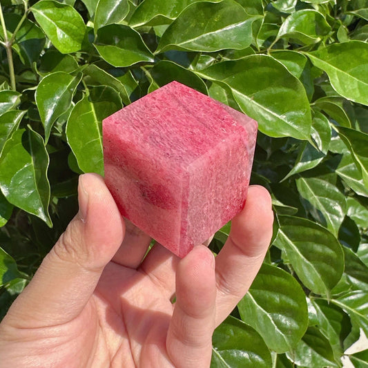 Close-up view of a Cherry Rhodonite Cube, showcasing its intricate natural texture and vibrant colors, perfect for crystal energy work and meditation.