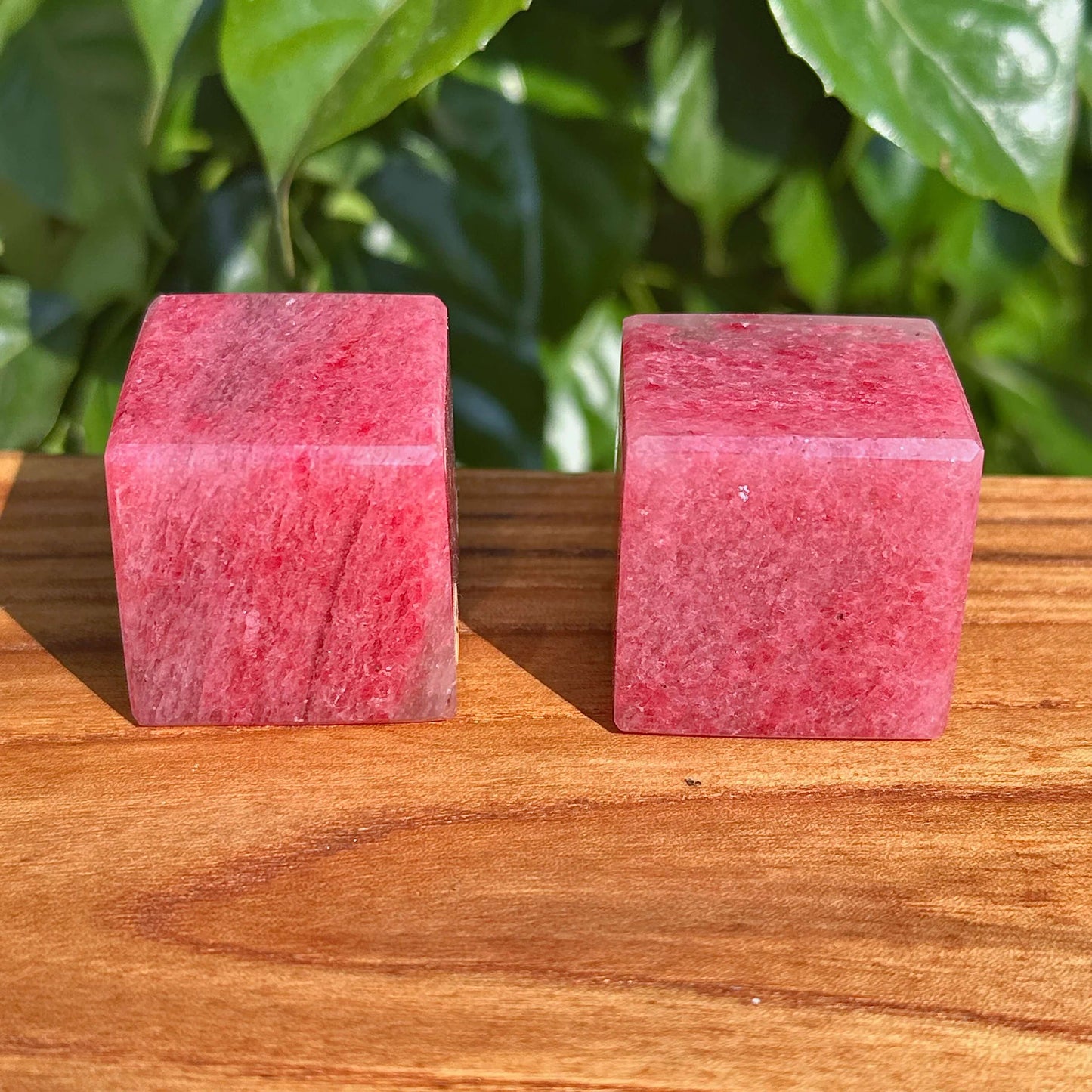 A stunning Cherry Rhodonite Cube showcasing its natural colors and smooth surface, perfect for crystal collectors and decorative purposes.