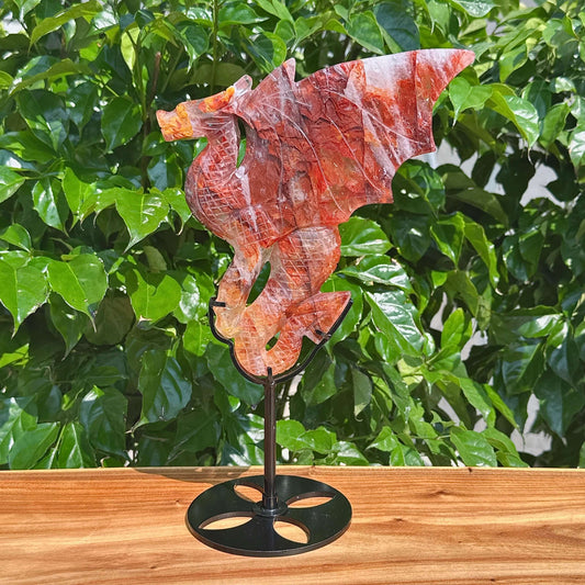 Close-up of a Fire Quartz Dragon Carving, showing detailed carving work and the vibrant color tones of the crystal.