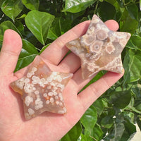 Handheld Flower Agate star carving showing unique patterns and crystal growth