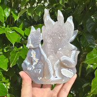 Side view of the Geode Agate Nine-Tailed Fox Carving highlighting the graceful design and agate texture.