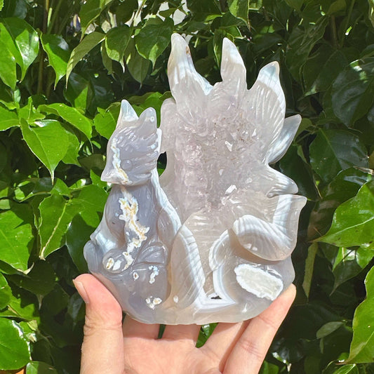 Side view of the Geode Agate Nine-Tailed Fox Carving highlighting the graceful design and agate texture.