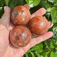 Golden Sunstone Sphere with radiant glow, showcasing vibrant orange and gold hues.