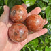 Golden Sunstone Sphere with radiant glow, showcasing vibrant orange and gold hues.
