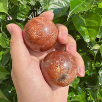 Close-up of Golden Sunstone Sphere, highlighting its sparkly surface and rich colors.