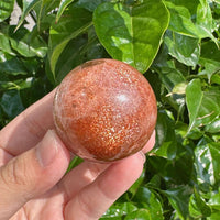 High-quality Golden Sunstone Sphere with smooth, polished surface, perfect for energy healing.
