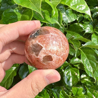 Vibrant Golden Sunstone Sphere, radiating warmth and energy, ideal for crystal healing.