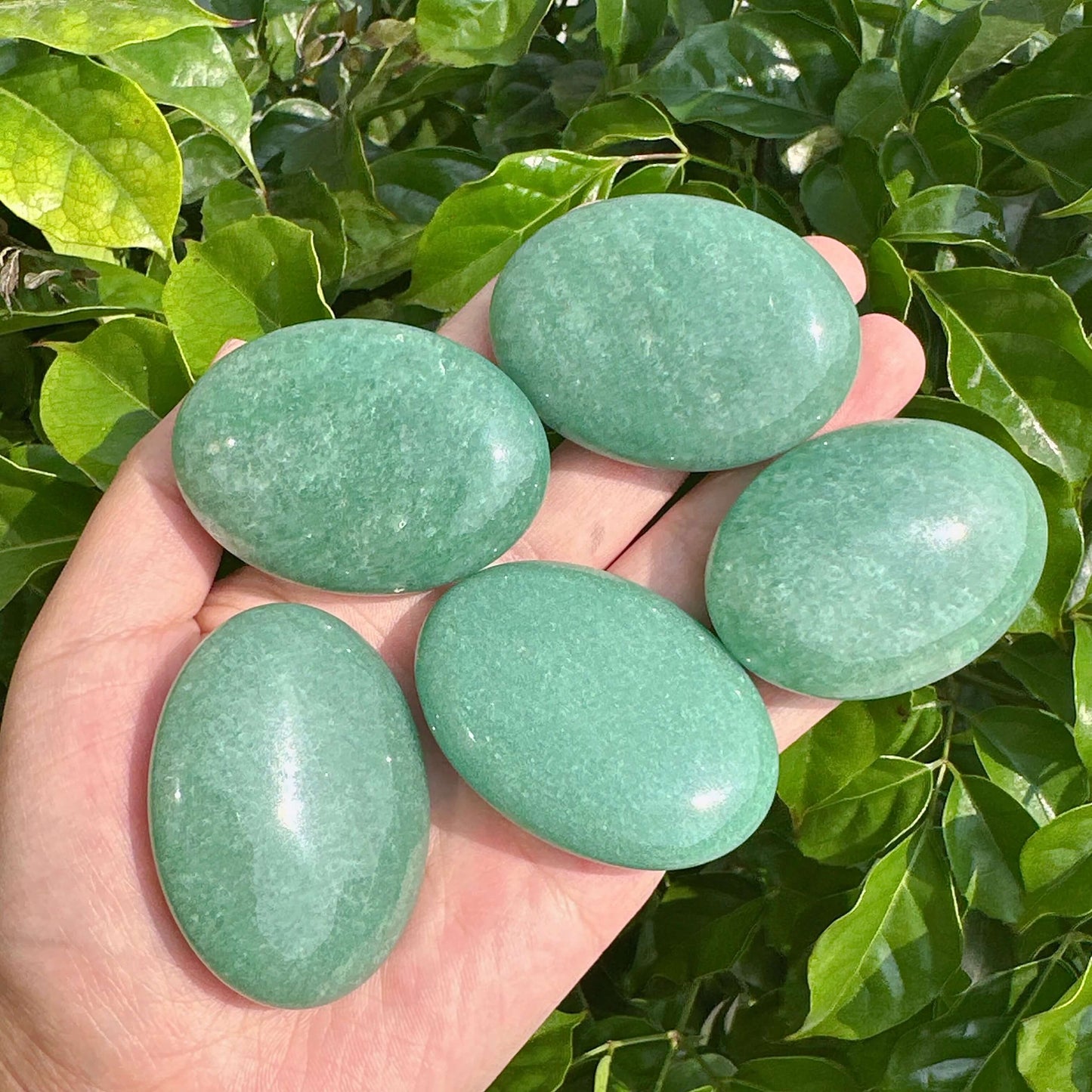 Elegant Green Aventurine Palm Stone showcasing its smooth texture and soothing green color.