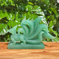 Close-up of Green Strawberry Quartz Nine-Tailed Fox Carving with fine detailing and beautiful color.