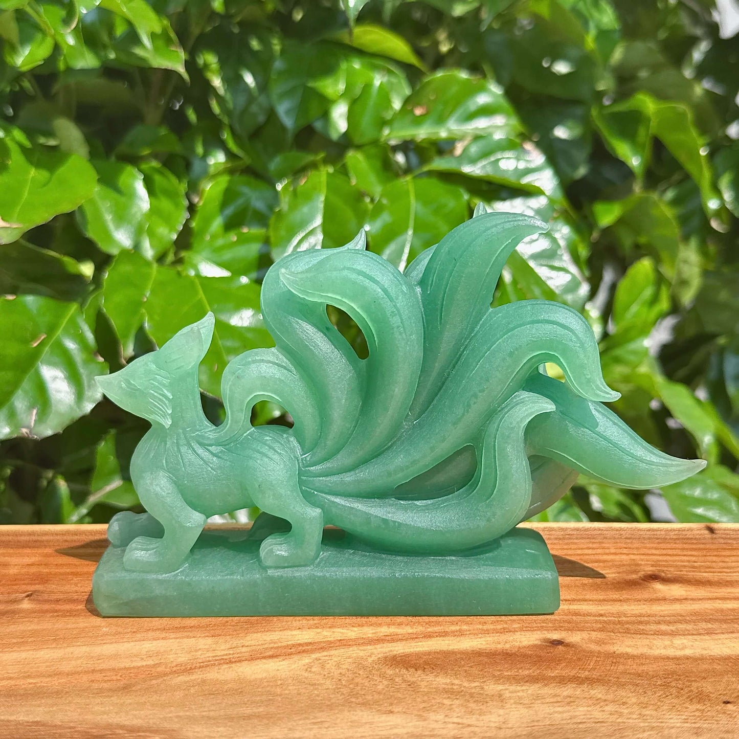 Close-up of Green Strawberry Quartz Nine-Tailed Fox Carving with fine detailing and beautiful color.